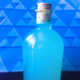 Bright blue cocktail in stoppered bottle